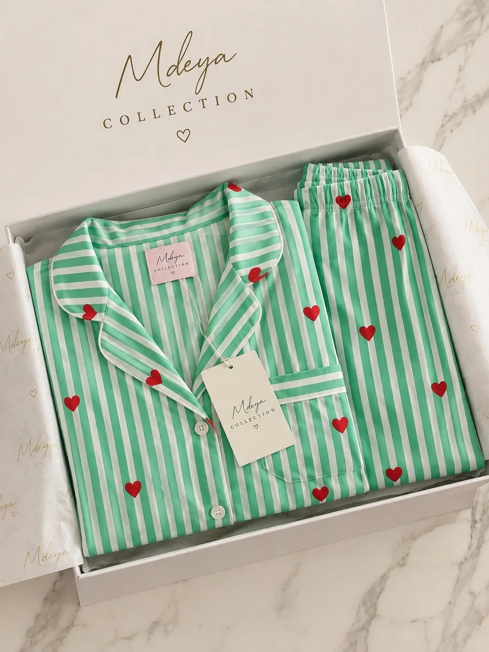 A Mint Hearts pajama set folded in the Mdeya gift box